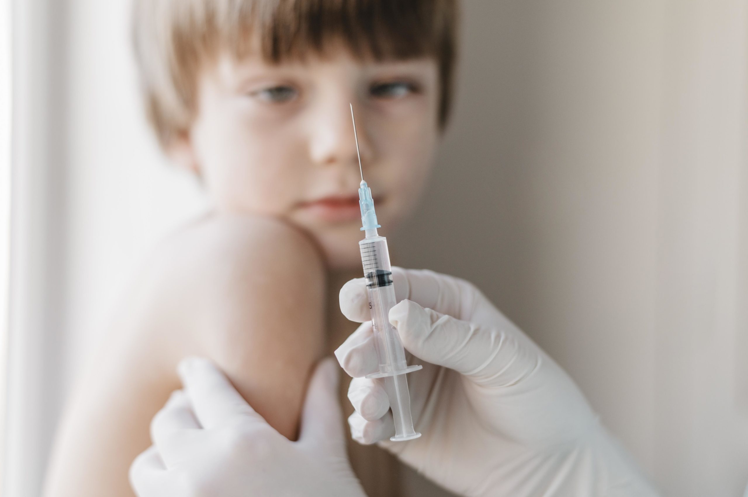child looking at polio vaccine